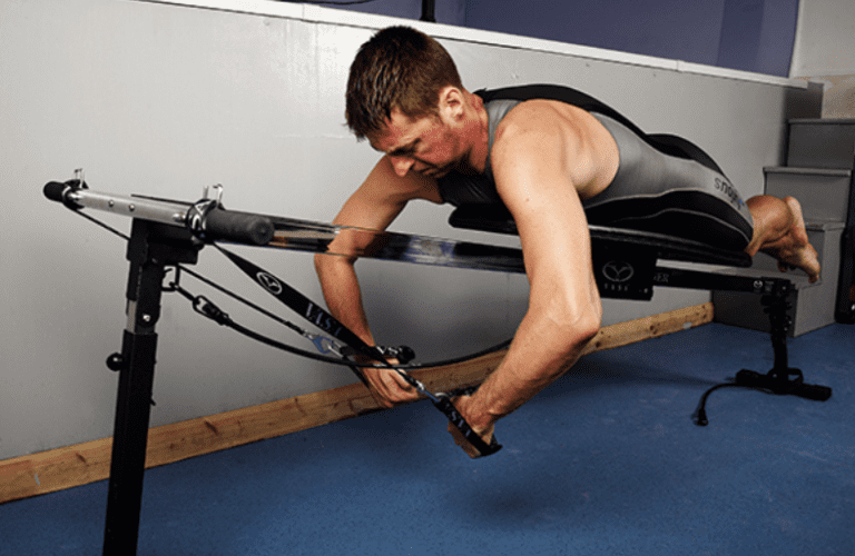 man on Vasa Trainer Pro in home gym