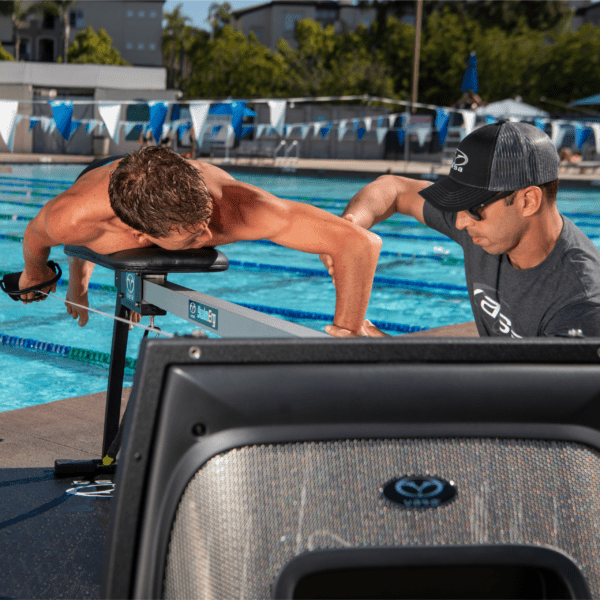 Coach showing teaching proper technique on the Vasa SwimErg