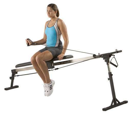 Woman performing shoulder external rotation on swim bench