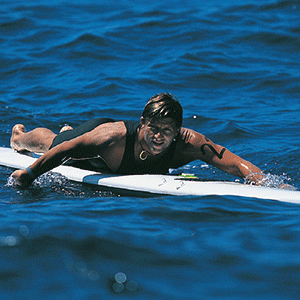 Surfer racing paddleboard